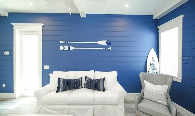 bedroom featuring beam ceiling and multiple windows