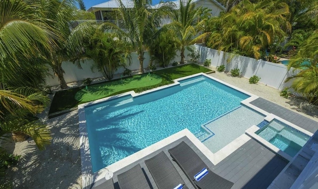 view of pool with an in ground hot tub