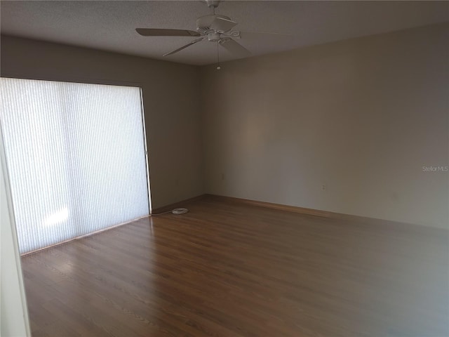 spare room featuring hardwood / wood-style floors and ceiling fan