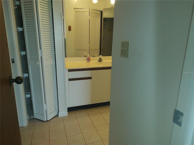 hall with light tile patterned floors and sink