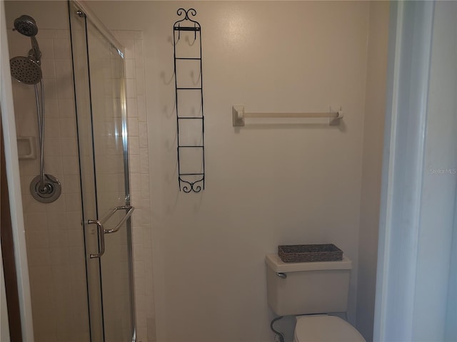 bathroom featuring an enclosed shower and toilet