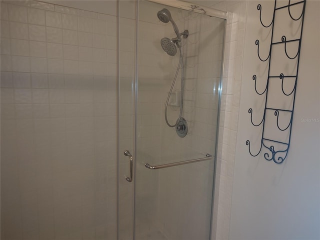 bathroom featuring a shower with door