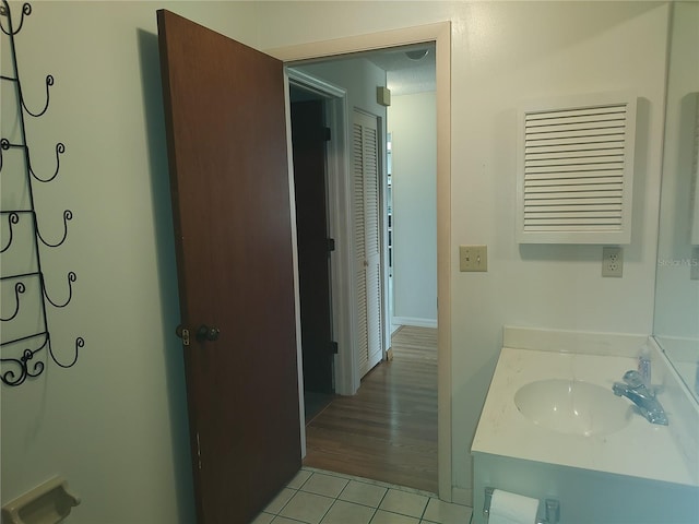 bathroom with tile patterned floors, vanity, and a textured ceiling