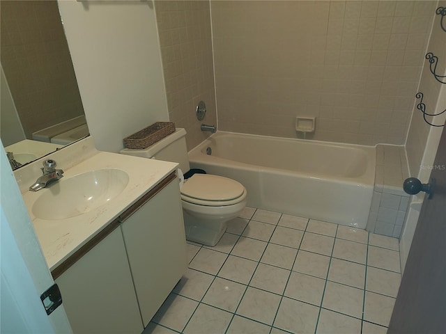 full bathroom with tile patterned floors, tiled shower / bath, vanity, and toilet