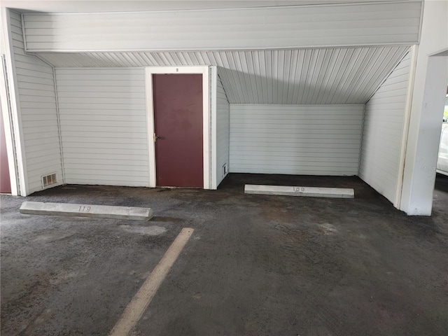 garage featuring wood walls