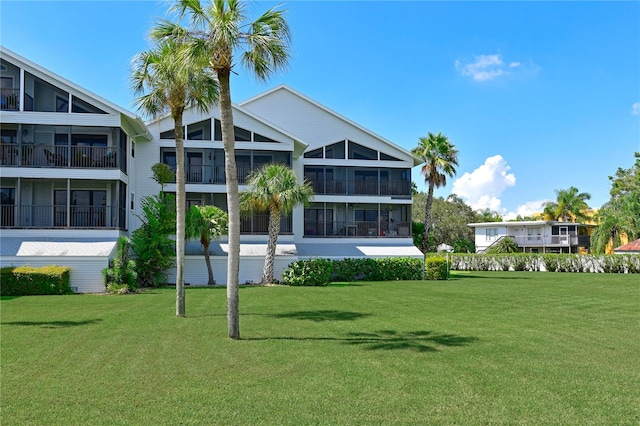 rear view of house featuring a yard