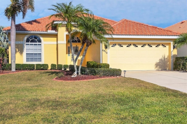 mediterranean / spanish-style house featuring a front yard and a garage