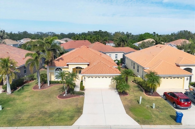 view of front of property with a garage and a front lawn