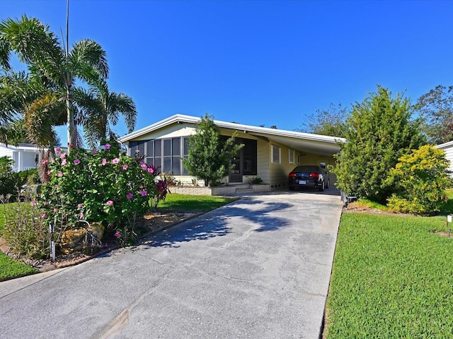 ranch-style home with a front yard and a carport