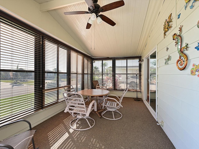 sunroom / solarium with lofted ceiling with beams, ceiling fan, and a healthy amount of sunlight