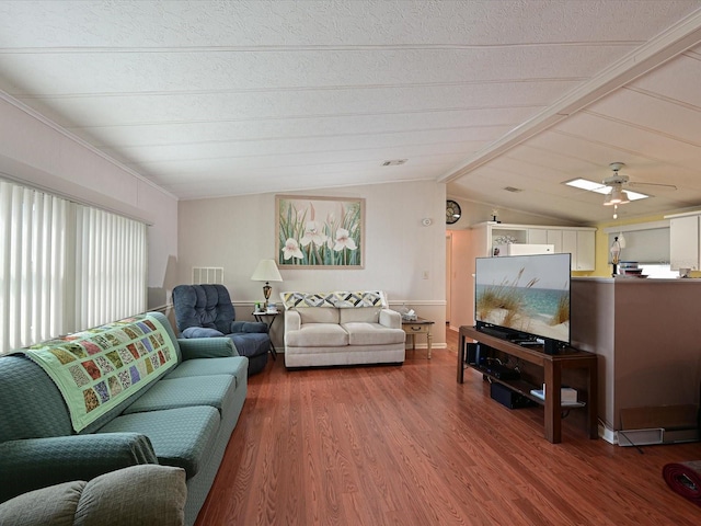 living room with ceiling fan, hardwood / wood-style floors, and lofted ceiling