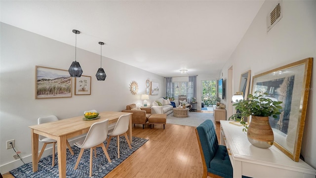 dining space with light hardwood / wood-style floors