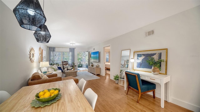 dining space featuring light wood-type flooring