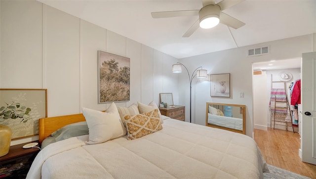 bedroom with light wood-type flooring and ceiling fan