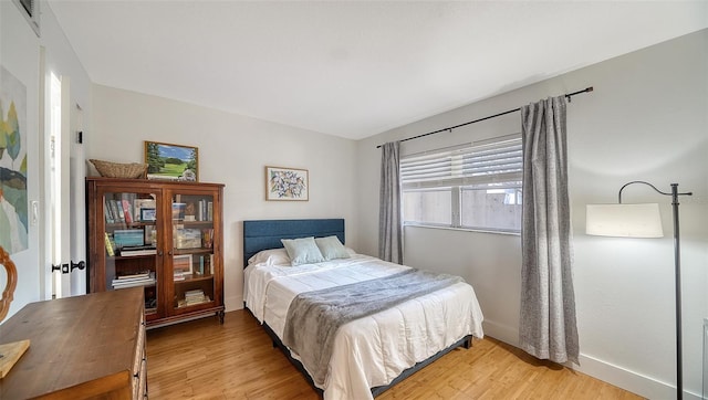 bedroom with hardwood / wood-style flooring