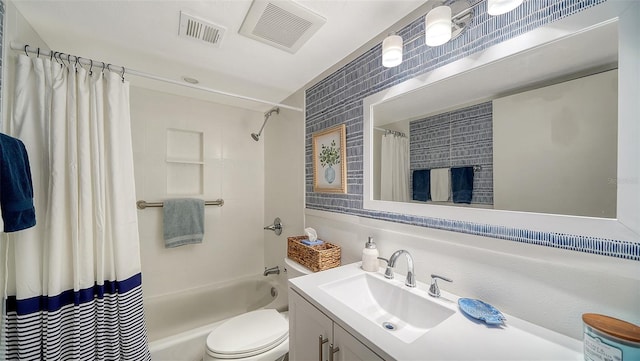 full bathroom featuring vanity, shower / bath combo, and toilet