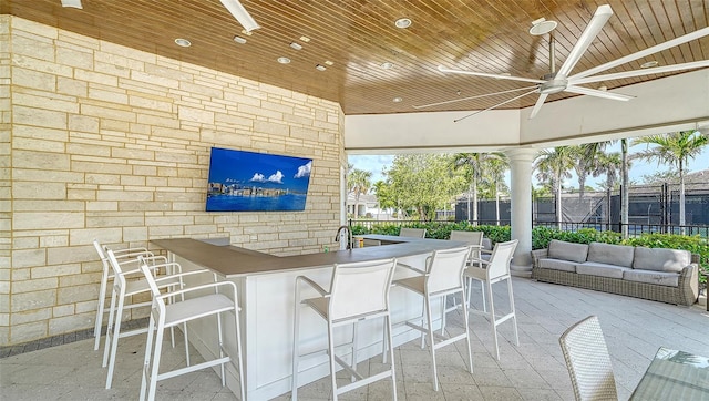 view of patio / terrace with a bar and ceiling fan