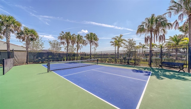 view of tennis court featuring basketball hoop