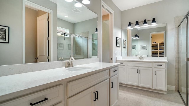 bathroom featuring tile patterned floors, vanity, and walk in shower