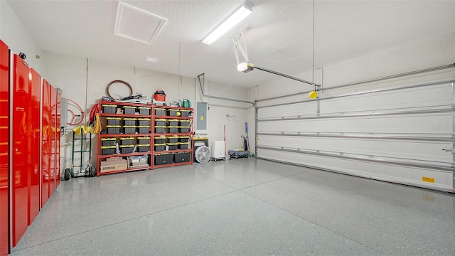 garage featuring a garage door opener and electric panel