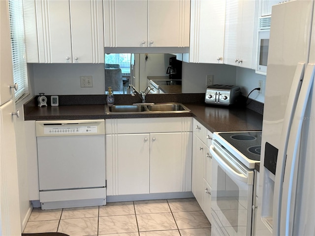 kitchen with white cabinets, white appliances, and sink