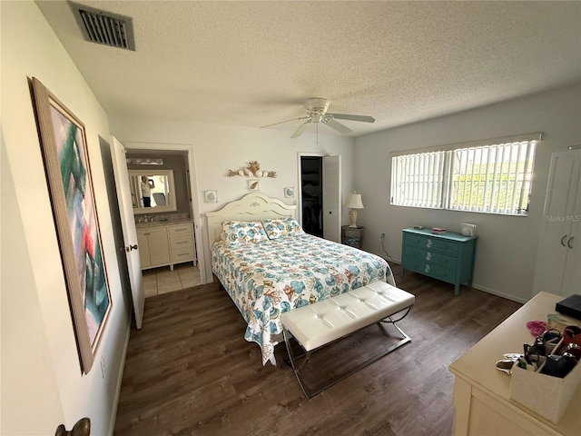 bedroom featuring ceiling fan, dark wood-type flooring, and a textured ceiling