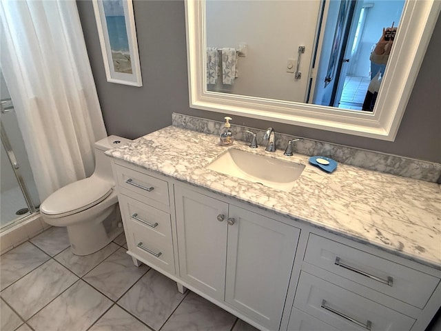 bathroom with vanity, toilet, and walk in shower