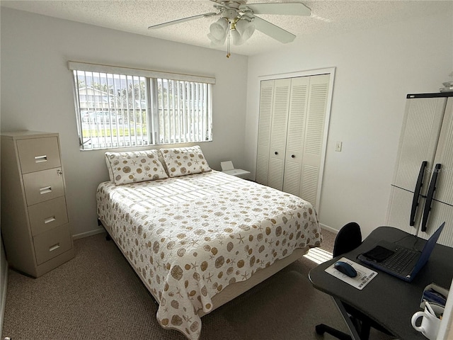 carpeted bedroom with a textured ceiling, a closet, and ceiling fan