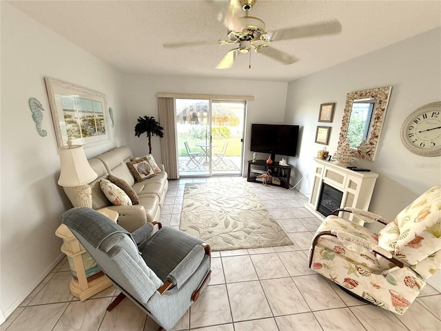 living room featuring a textured ceiling and ceiling fan