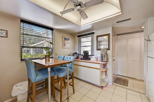 tiled dining area featuring plenty of natural light and ceiling fan