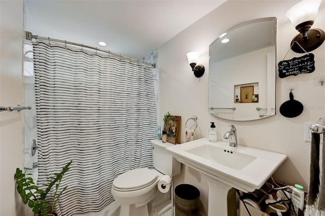 bathroom featuring curtained shower and toilet