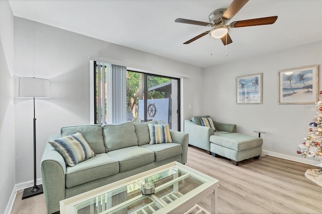 living room with ceiling fan and light hardwood / wood-style floors