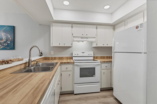 kitchen with white cabinets, light wood-type flooring, white appliances, and sink