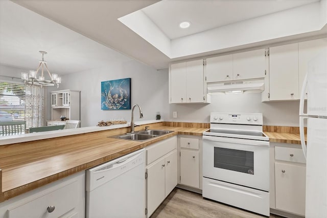 kitchen with pendant lighting, white cabinetry, white appliances, and sink