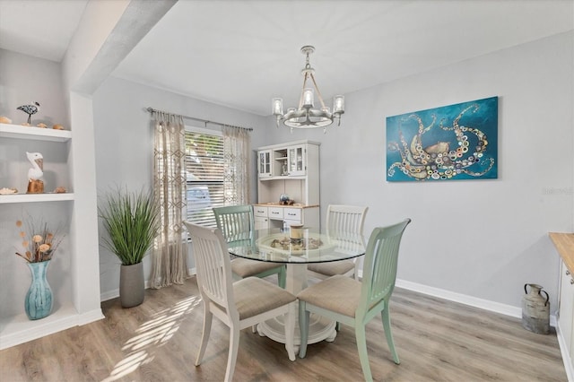 dining area featuring hardwood / wood-style floors and a chandelier