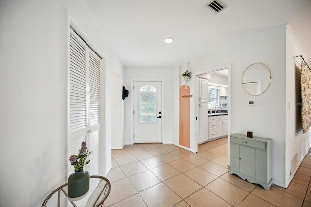 foyer with sink and light tile patterned flooring