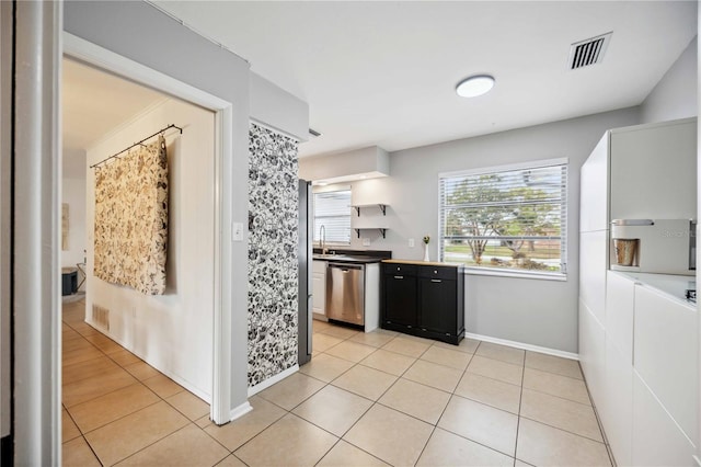 kitchen featuring dishwasher, light tile patterned flooring, and sink