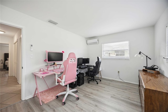 office with light wood-type flooring and a wall unit AC