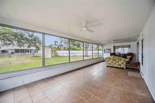 unfurnished sunroom featuring ceiling fan