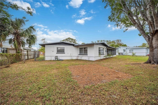 back of property with a lawn