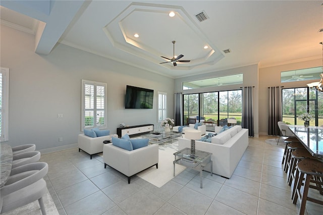 living area featuring visible vents, ornamental molding, baseboards, and light tile patterned flooring