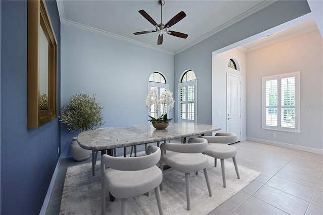 dining area featuring light tile patterned floors, plenty of natural light, baseboards, and crown molding