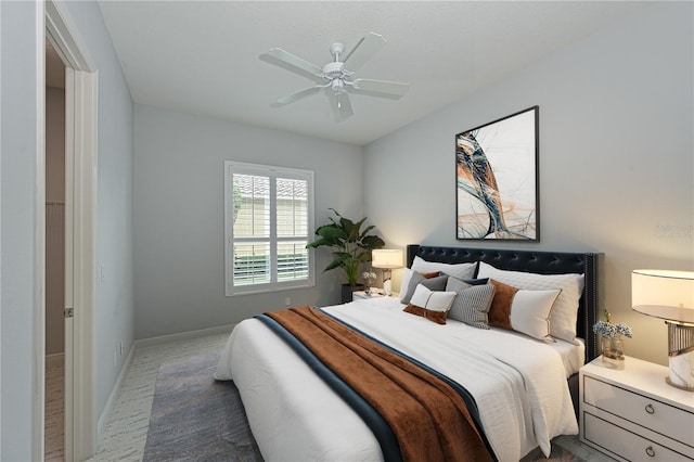 bedroom featuring ceiling fan and baseboards