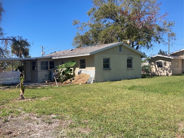 back of property with a lawn