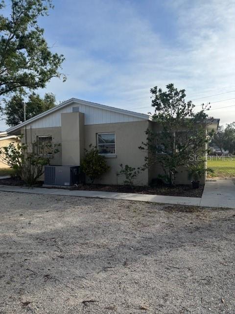 view of side of property with central AC