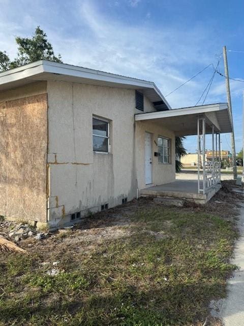 view of side of home with covered porch