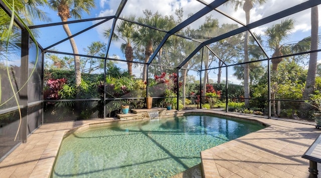 view of swimming pool featuring glass enclosure and a patio