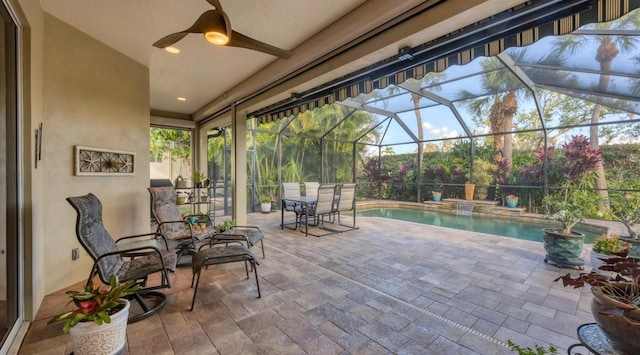 view of patio with ceiling fan and a lanai