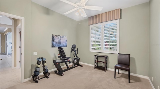 exercise area with ceiling fan and light colored carpet