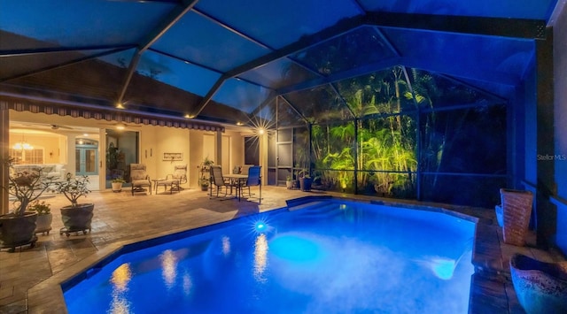 view of swimming pool featuring a patio, ceiling fan, and a lanai